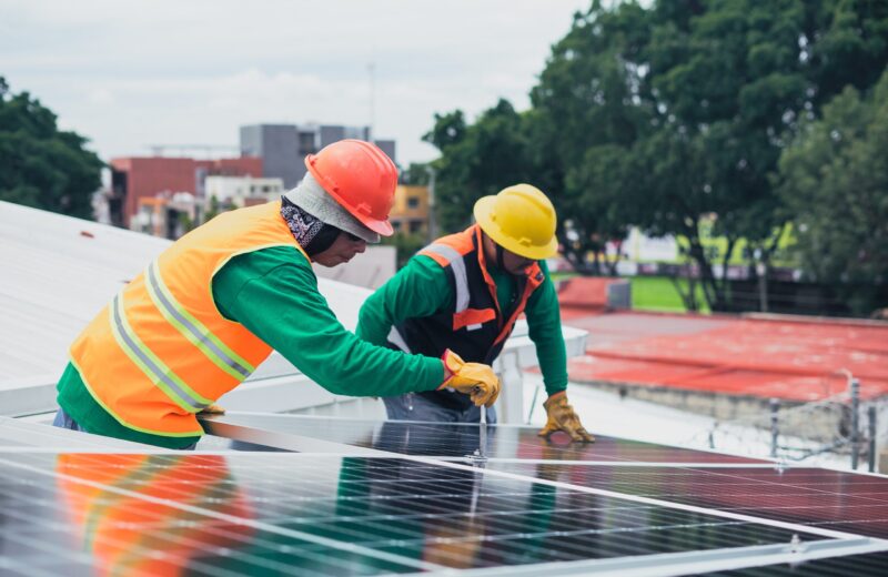 Two men working on a solar panel.